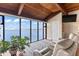 Bright living room with wood ceiling, water views, and large picture windows to let in natural light at 761 Marina Point Dr # 7610, Daytona Beach, FL 32114
