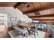 Inviting living room featuring exposed wood beams, a dining table, and a cozy seating area at 761 Marina Point Dr # 7610, Daytona Beach, FL 32114