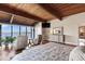 Spacious main bedroom with wood planked ceilings, waterfront views and luxurious furnishings at 761 Marina Point Dr # 7610, Daytona Beach, FL 32114