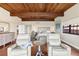 Spacious main bedroom with hardwood floors, wood plank ceiling, and two plush white chairs at 761 Marina Point Dr # 7610, Daytona Beach, FL 32114