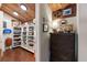 Organized storage area with shelving units and a dark wicker chest at 761 Marina Point Dr # 7610, Daytona Beach, FL 32114