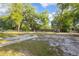 Large backyard with trees, grass and fence at 816 W Franklin Ave, Deland, FL 32720