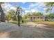 Large backyard showcasing ample room for outdoor enjoyment, mature trees, and convenient access to the house at 816 W Franklin Ave, Deland, FL 32720