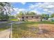 Charming home exterior with a well-kept lawn, mature trees, and a welcoming backyard space at 816 W Franklin Ave, Deland, FL 32720