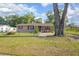 Welcoming single-story house with a fenced-in yard and mature tree at 816 W Franklin Ave, Deland, FL 32720