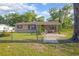 Cozy single-Gathering home boasts a fenced yard with mature trees at 816 W Franklin Ave, Deland, FL 32720