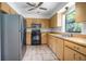 Functional kitchen with stainless steel refrigerator and ample cabinet storage at 816 W Franklin Ave, Deland, FL 32720