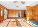 Spacious living room features wood-look floors and wood-paneled walls at 816 W Franklin Ave, Deland, FL 32720