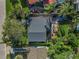 Aerial view of the home showcases its outdoor living space with lush landscaping and a brick patio at 82 Margaret Rd, Ormond Beach, FL 32176