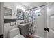 Bathroom with tiled shower, modern vanity, and beach-themed decor at 82 Margaret Rd, Ormond Beach, FL 32176
