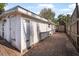 Back of home with brick paved walkway and patio with backyard privacy fencing at 82 Margaret Rd, Ormond Beach, FL 32176