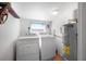 A laundry room with a washer, dryer, and water heater at 82 Margaret Rd, Ormond Beach, FL 32176