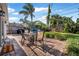 Inviting outdoor patio with a dining set and well-maintained landscaping and fenced yard at 82 Margaret Rd, Ormond Beach, FL 32176