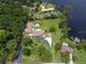 Aerial view displaying the property with a pool and an expansive green lawn surrounded by mature trees at 910 N Kepler Rd, Deland, FL 32724