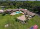 Aerial view of a sprawling home with a pool and patio surrounded by lush greenery at 910 N Kepler Rd, Deland, FL 32724