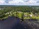 Stunning aerial view of waterfront home nestled among lush trees along the tranquil lake at 910 N Kepler Rd, Deland, FL 32724