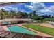Aerial view of the property with a pool, large lawn, and lush green landscaping, surrounded by mature trees at 910 N Kepler Rd, Deland, FL 32724