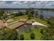 Aerial view showcasing the property with a pool, lawn, driveway, and lake views at 910 N Kepler Rd, Deland, FL 32724
