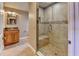 Bathroom featuring a tiled walk-in shower and wooden vanity at 910 N Kepler Rd, Deland, FL 32724