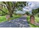 Long driveway flanked by brick pillars and mature trees leading to this lovely home at 910 N Kepler Rd, Deland, FL 32724