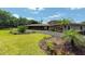Beautifully landscaped property features a winding driveway, lush lawn, and well-maintained greenery at 910 N Kepler Rd, Deland, FL 32724