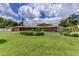 Spacious single-story home featuring a lush front lawn and meticulously maintained landscaping at 910 N Kepler Rd, Deland, FL 32724