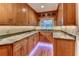 A charming kitchen with wood cabinets, granite countertops, and under-cabinet lighting at 910 N Kepler Rd, Deland, FL 32724