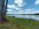 Picturesque lake view from the grassy lawn, with scattered trees, offering a peaceful waterside setting at 910 N Kepler Rd, Deland, FL 32724