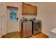 Bright laundry room with new stainless steel washer and dryer at 910 N Kepler Rd, Deland, FL 32724