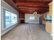 Living room featuring a fireplace, wood ceilings, and large window at 910 N Kepler Rd, Deland, FL 32724