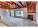 Spacious living room boasts a stone fireplace, wood ceilings, and a view of the pool at 910 N Kepler Rd, Deland, FL 32724