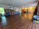 Large open room with wood flooring, neutral walls and backyard views at 910 N Kepler Rd, Deland, FL 32724