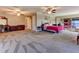 Large main bedroom featuring multiple ceiling fans, carpet flooring, and lots of space for furniture at 910 N Kepler Rd, Deland, FL 32724