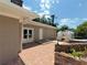 Brick patio area with greenhouse, surrounded by a beautiful garden, next to the house at 910 N Kepler Rd, Deland, FL 32724