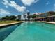 Backyard featuring a large inground pool and a lakeside view, ideal for relaxing and entertaining at 910 N Kepler Rd, Deland, FL 32724