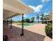 A backyard featuring a pool, brick patio and black posts, with a view of the lake and some trees at 910 N Kepler Rd, Deland, FL 32724