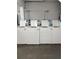 A functional laundry room with multiple commercial-grade washing machines at 935 S Atlantic Ave # 364, Daytona Beach, FL 32118