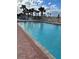 Community swimming pool surrounded by palm trees and lounge chairs at 935 S Atlantic Ave # 364, Daytona Beach, FL 32118