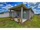Charming backyard with a covered patio, lush green lawn, and flower pots, perfect for relaxation at 1002 Chelan Falls Dr, Deland, FL 32724