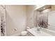 Cozy bathroom features a large mirror, toilet, and shower-tub combination with flower shower curtain at 1002 Chelan Falls Dr, Deland, FL 32724