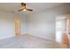 A spacious bedroom boasts a ceiling fan and neutral carpet at 1002 Chelan Falls Dr, Deland, FL 32724