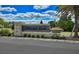 Stone entrance sign for Lakewood Park surrounded by mature landscaping and flowers at 1002 Chelan Falls Dr, Deland, FL 32724
