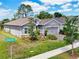 Beautifully landscaped home with a gray exterior, green lawn and view of Chelan Falls Dr at 1002 Chelan Falls Dr, Deland, FL 32724