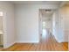 Bright hallway with wood floors, white walls, and natural light with access to bathroom at 1002 Chelan Falls Dr, Deland, FL 32724