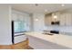 Modern kitchen with white cabinetry, quartz countertops, stainless steel appliances, and pendant lighting at 1002 Chelan Falls Dr, Deland, FL 32724