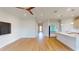 Open floor plan featuring a kitchen with island overlooking the spacious living room with wood floors at 1002 Chelan Falls Dr, Deland, FL 32724