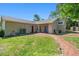 A expansive backyard including lush green lawn and brick walkway at 101 Sweetwater Oaks Ln, Daytona Beach, FL 32114