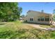 The large backyard featuring a brick pathway and mature trees providing ample shade at 101 Sweetwater Oaks Ln, Daytona Beach, FL 32114
