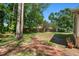 A sprawling backyard with lush green lawn, brick pathway, and privacy fence at 101 Sweetwater Oaks Ln, Daytona Beach, FL 32114