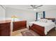 Bedroom with wood floors, a ceiling fan, and a large window with blue curtains at 101 Sweetwater Oaks Ln, Daytona Beach, FL 32114